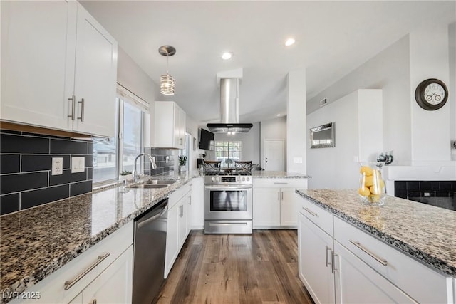 6552 Sweetzer Way, Las Vegas, NV 89108 - kitchen with appliances with stainless steel finishes, island range hood, dark wood-style floors, white cabinetry, and recessed lighting