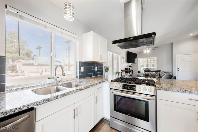 6552 Sweetzer Way, Las Vegas, NV 89108 - kitchen with appliances with stainless steel finishes, wall chimney range hood, light stone counters, ceiling fan, and white cabinets
