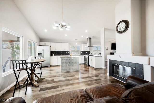 6552 Sweetzer Way, Las Vegas, NV 89108 - living area with plenty of natural light, a chandelier, recessed lighting, high vaulted ceiling, and a tile fireplace