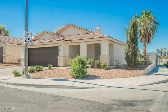 6552 Sweetzer Way, Las Vegas, NV 89108 - view of front facade featuring a garage, driveway, a tile roof, stucco siding, and a chimney
