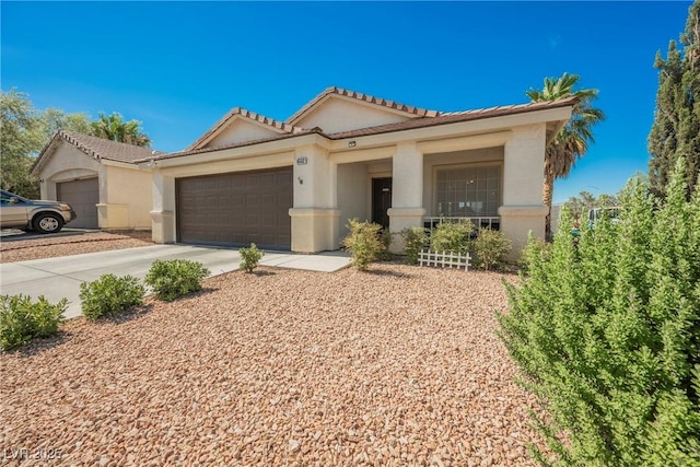 6552 Sweetzer Way, Las Vegas, NV 89108 - view of front of home with an attached garage, concrete driveway, stucco siding, and a tile roof