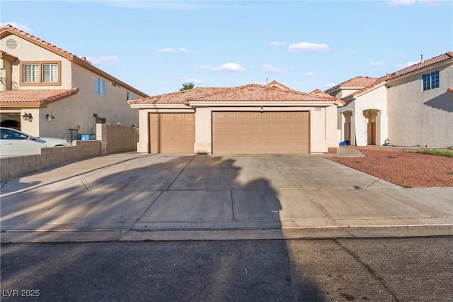 5616 Royal Castle Ln, Las Vegas, NV 89130 - mediterranean / spanish home with stucco siding, concrete driveway, a tile roof, and a garage