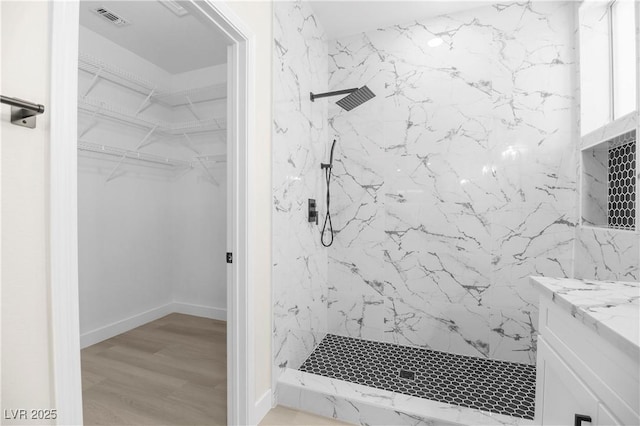 2118 High Mesa Dr, Henderson, NV 89012 - bathroom featuring a marble finish shower, vanity, wood finished floors, and a walk in closet
