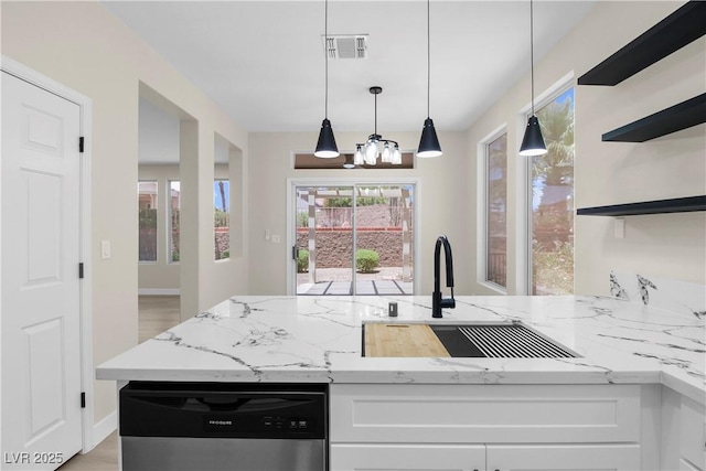 2118 High Mesa Dr, Henderson, NV 89012 - kitchen with stainless steel dishwasher, light stone countertops, white cabinets, and open shelves