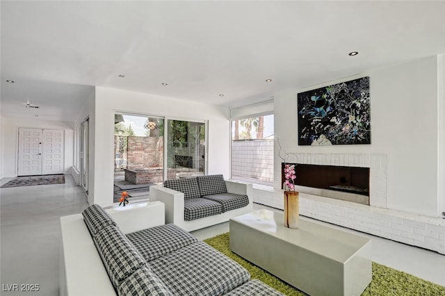 2095 Mohigan Way, Las Vegas, NV 89169 - living area featuring recessed lighting, a fireplace, and concrete floors