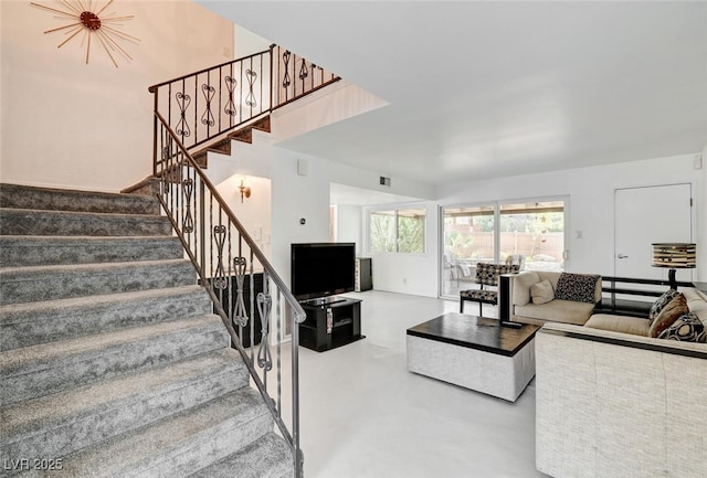 2095 Mohigan Way, Las Vegas, NV 89169 - living room featuring stairs and finished concrete flooring