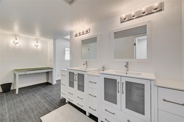 2095 Mohigan Way, Las Vegas, NV 89169 - bathroom with two vanities and baseboards
