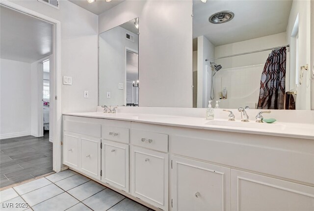 2095 Mohigan Way, Las Vegas, NV 89169 - full bathroom featuring double vanity, a shower with shower curtain, and tile patterned flooring