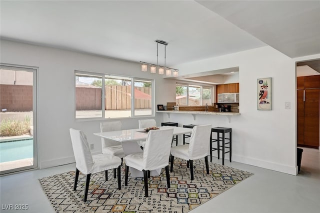 2095 Mohigan Way, Las Vegas, NV 89169 - dining room with finished concrete flooring and baseboards