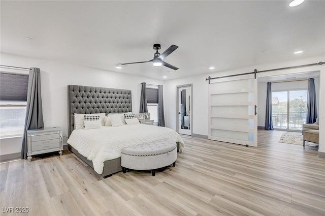 7024 Geese Gathering St, North Las Vegas, NV 89084 - bedroom with recessed lighting, a barn door, light wood-type flooring, and ceiling fan