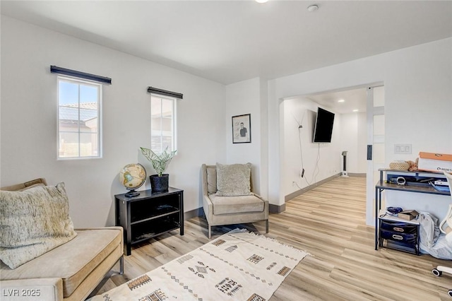 7024 Geese Gathering St, North Las Vegas, NV 89084 - living area featuring light wood-style flooring and baseboards