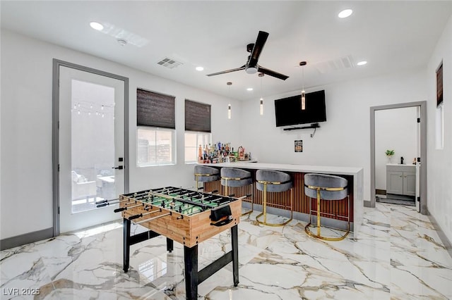 7024 Geese Gathering St, North Las Vegas, NV 89084 - rec room with a dry bar, ceiling fan, light marble finish floors, and recessed lighting