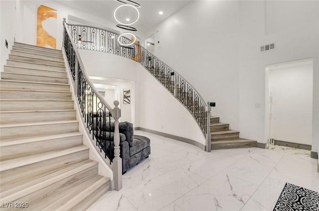 7024 Geese Gathering St, North Las Vegas, NV 89084 - staircase with a towering ceiling, marble tiled flooring, and recessed lighting