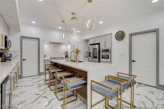 7024 Geese Gathering St, North Las Vegas, NV 89084 - kitchen featuring appliances with stainless steel finishes, recessed lighting, light marble finish flooring, gray cabinets, and light stone countertops