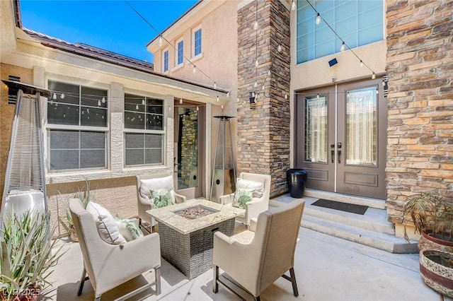7024 Geese Gathering St, North Las Vegas, NV 89084 - view of patio featuring french doors and an outdoor fire pit