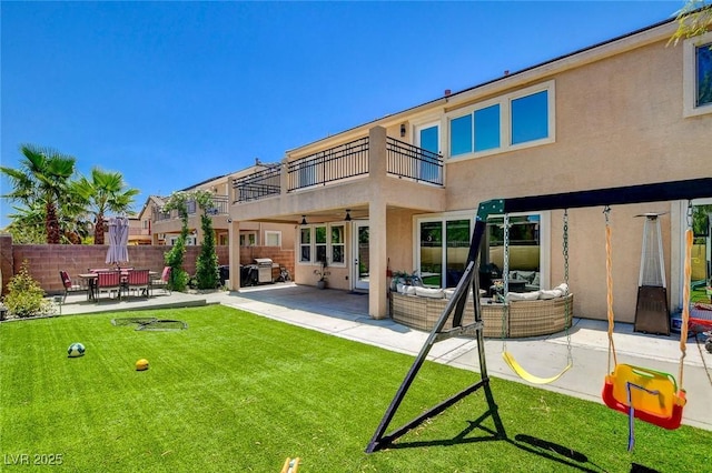 7024 Geese Gathering St, North Las Vegas, NV 89084 - rear view of house with a balcony, stucco siding, a patio area, and outdoor lounge area