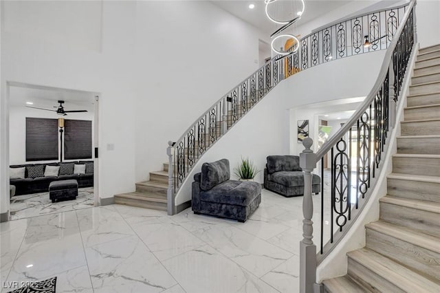 7024 Geese Gathering St, North Las Vegas, NV 89084 - stairway with a towering ceiling, marble tiled flooring, a ceiling fan, and recessed lighting