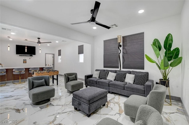 7024 Geese Gathering St, North Las Vegas, NV 89084 - living room with ceiling fan, marble tiled flooring, recessed lighting, and bar area