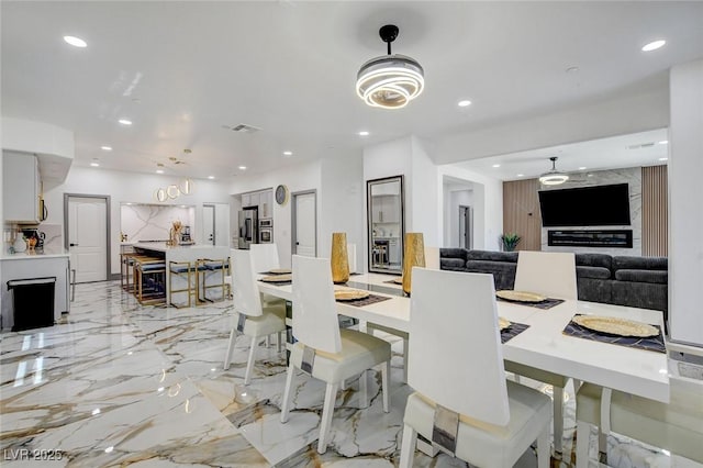 7024 Geese Gathering St, North Las Vegas, NV 89084 - dining area with recessed lighting and light marble finish flooring