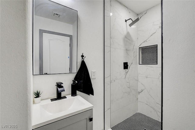 7024 Geese Gathering St, North Las Vegas, NV 89084 - full bathroom with vanity, a marble finish shower, and a textured wall