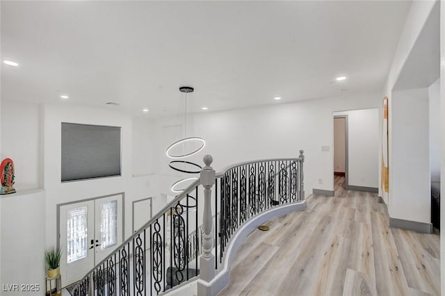 7024 Geese Gathering St, North Las Vegas, NV 89084 - corridor with an upstairs landing, wood finished floors, recessed lighting, and french doors