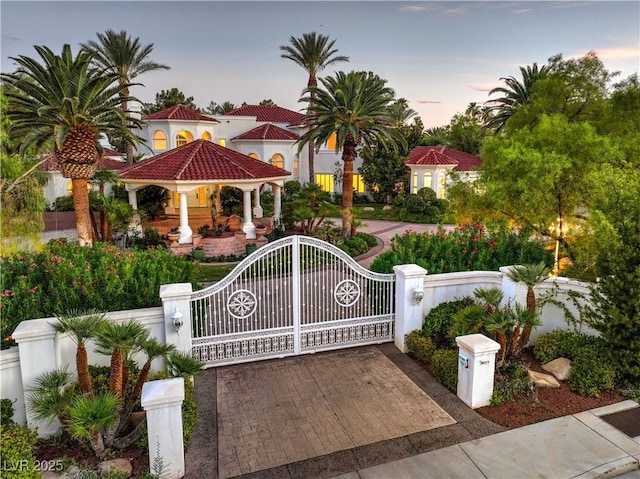 8021 Obannon Dr, Las Vegas, NV 89117 - gate at dusk featuring a fenced front yard and a gazebo