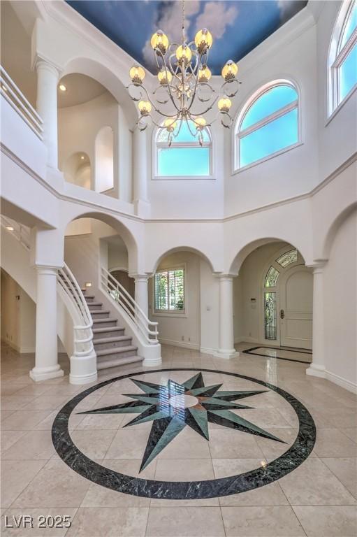 8021 Obannon Dr, Las Vegas, NV 89117 - foyer entrance featuring a high ceiling, inlaid floor details, and a chandelier