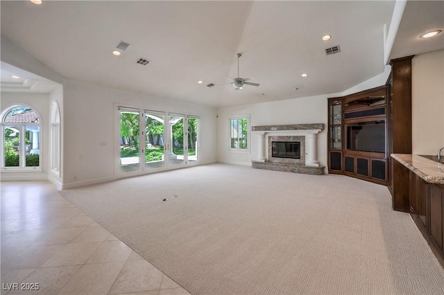 8021 Obannon Dr, Las Vegas, NV 89117 - unfurnished living room featuring light colored carpet, ceiling fan, a high end fireplace, recessed lighting, and light tile patterned floors