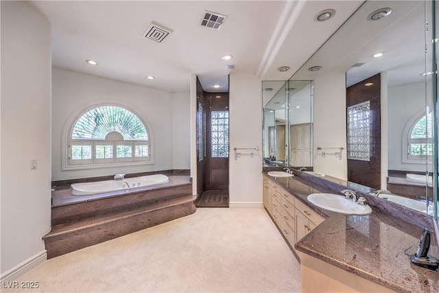 8021 Obannon Dr, Las Vegas, NV 89117 - bathroom featuring a bath, double vanity, a shower stall, and recessed lighting