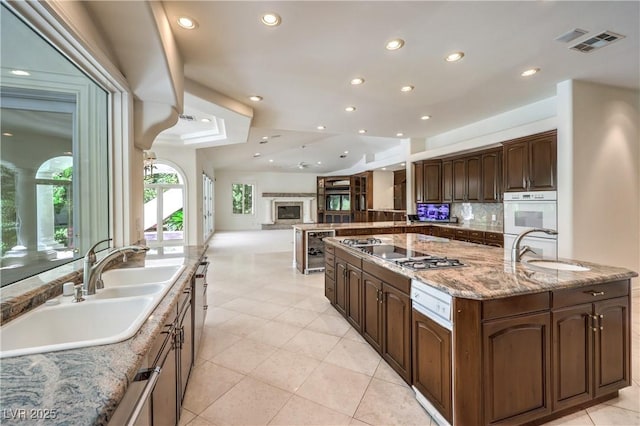 8021 Obannon Dr, Las Vegas, NV 89117 - kitchen featuring wine cooler, stovetop, recessed lighting, open floor plan, and light tile patterned floors