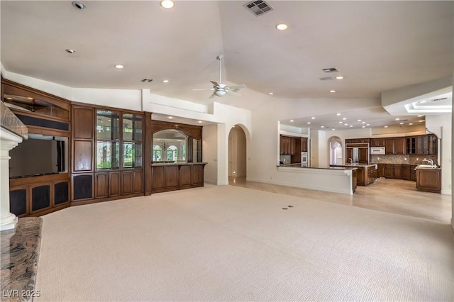 8021 Obannon Dr, Las Vegas, NV 89117 - unfurnished living room with arched walkways, recessed lighting, a ceiling fan, and vaulted ceiling
