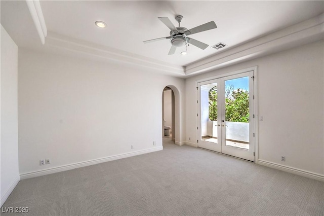 8021 Obannon Dr, Las Vegas, NV 89117 - unfurnished room featuring a raised ceiling, french doors, carpet floors, arched walkways, and ceiling fan