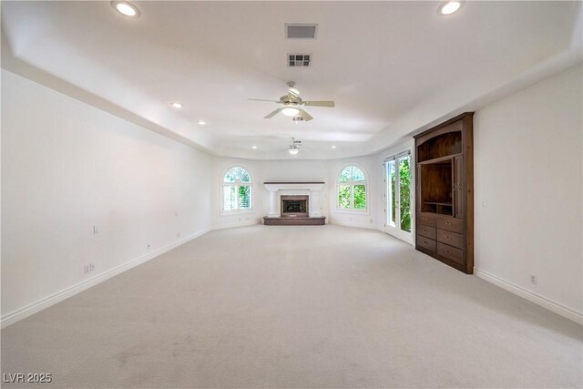 8021 Obannon Dr, Las Vegas, NV 89117 - unfurnished living room featuring a ceiling fan, recessed lighting, light carpet, and a fireplace with raised hearth