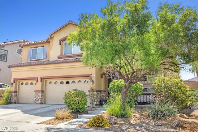 1141 Brent Park Ct, Henderson, NV 89002 - mediterranean / spanish-style home featuring concrete driveway, a tiled roof, an attached garage, stucco siding, and stone siding