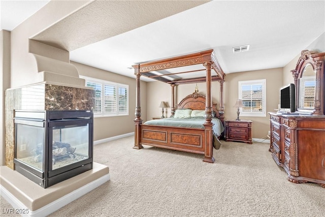 1141 Brent Park Ct, Henderson, NV 89002 - bedroom featuring carpet floors and a multi sided fireplace
