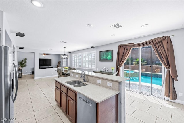1141 Brent Park Ct, Henderson, NV 89002 - kitchen with appliances with stainless steel finishes, light tile patterned floors, open floor plan, a chandelier, and recessed lighting