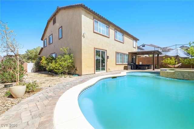 1141 Brent Park Ct, Henderson, NV 89002 - back of property with stucco siding, a pool with connected hot tub, a gazebo, a patio, and outdoor lounge area