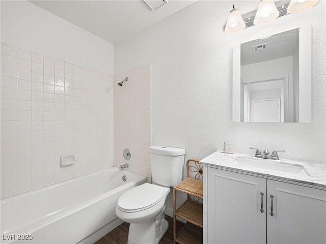 2214 Pebble Creek Ln, Laughlin, NV 89029 - bathroom featuring vanity,  shower combination, wood finished floors, and a textured wall