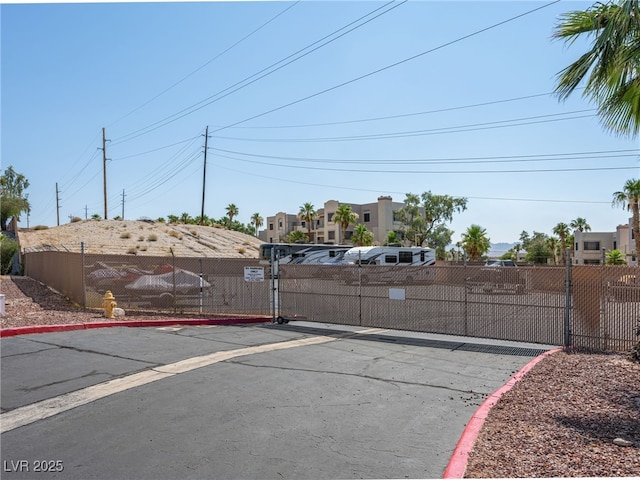 2214 Pebble Creek Ln, Laughlin, NV 89029 - view of asphalt road with a gate and curbs