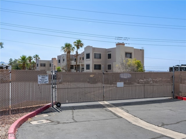 2214 Pebble Creek Ln, Laughlin, NV 89029 - view of asphalt road with a gate and curbs
