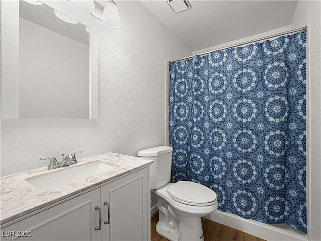 2214 Pebble Creek Ln, Laughlin, NV 89029 - full bath with a textured wall, wood finished floors, vanity, and a shower with curtain