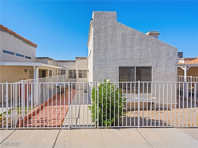 2214 Pebble Creek Ln, Laughlin, NV 89029 - view of front of property featuring stucco siding and a chimney