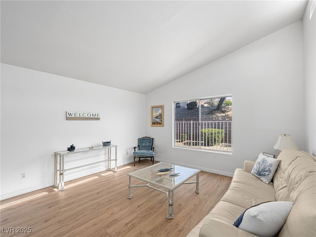 2214 Pebble Creek Ln, Laughlin, NV 89029 - living room featuring vaulted ceiling and wood finished floors