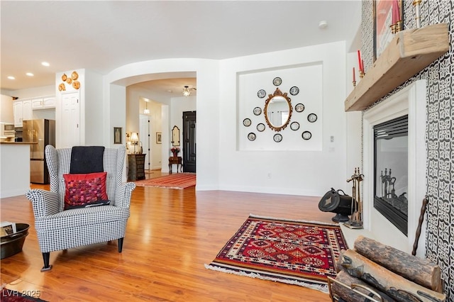 7209 Millerbird St, North Las Vegas, NV 89084 - living room featuring light wood-style floors, arched walkways, and recessed lighting