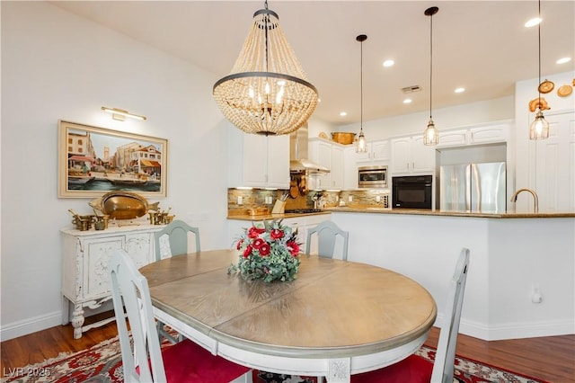 7209 Millerbird St, North Las Vegas, NV 89084 - dining room with wood finished floors, a chandelier, and recessed lighting