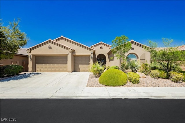 7209 Millerbird St, North Las Vegas, NV 89084 - mediterranean / spanish-style house with an attached garage, stucco siding, driveway, and a tile roof