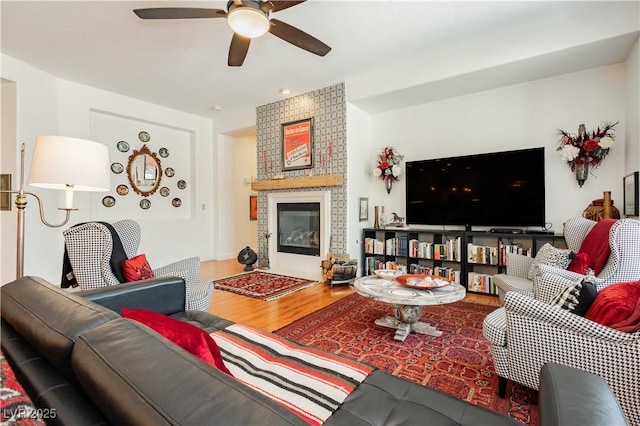 7209 Millerbird St, North Las Vegas, NV 89084 - living room with wood finished floors, ceiling fan, and a fireplace