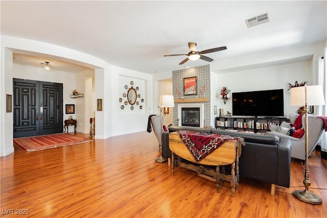 7209 Millerbird St, North Las Vegas, NV 89084 - living area with ceiling fan, light wood finished floors, and a fireplace