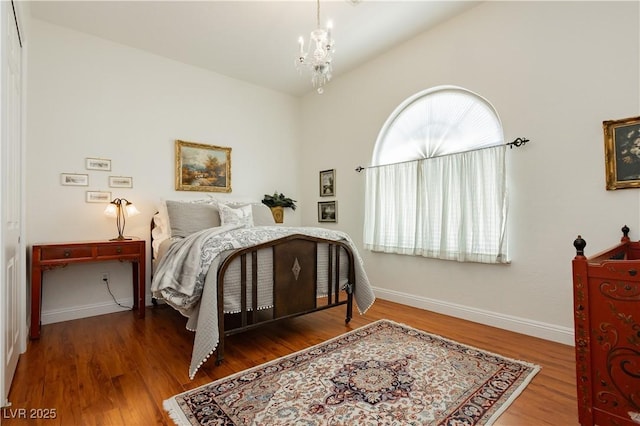 7209 Millerbird St, North Las Vegas, NV 89084 - bedroom featuring a chandelier, vaulted ceiling, and wood finished floors