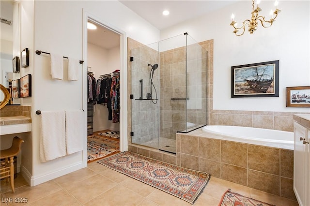 7209 Millerbird St, North Las Vegas, NV 89084 - full bath with tile patterned flooring, a shower stall, a garden tub, a chandelier, and a walk in closet